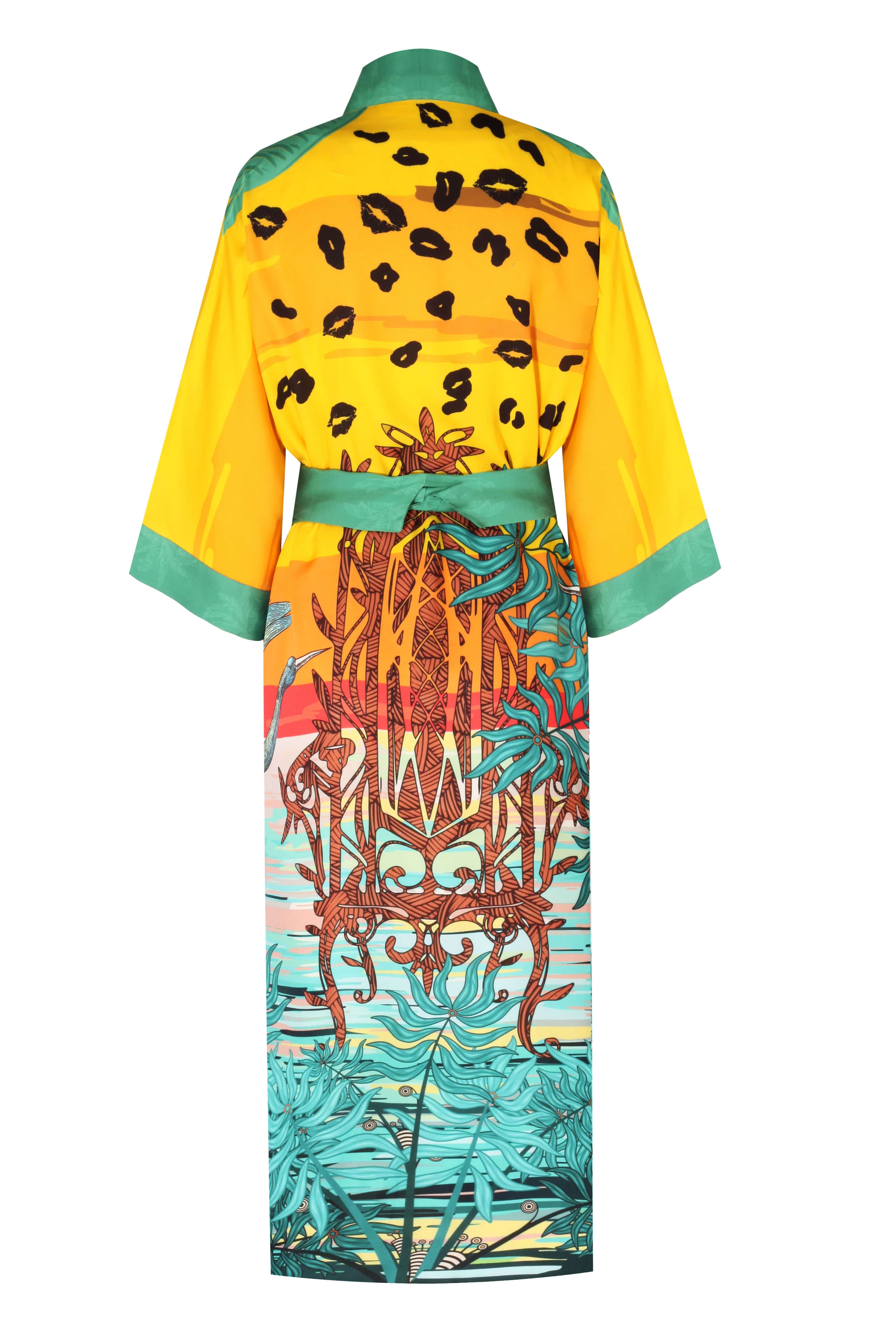 Back view of JULIETTA CAFTAN featuring leopard print and vibrant tropical design on a yellow background.