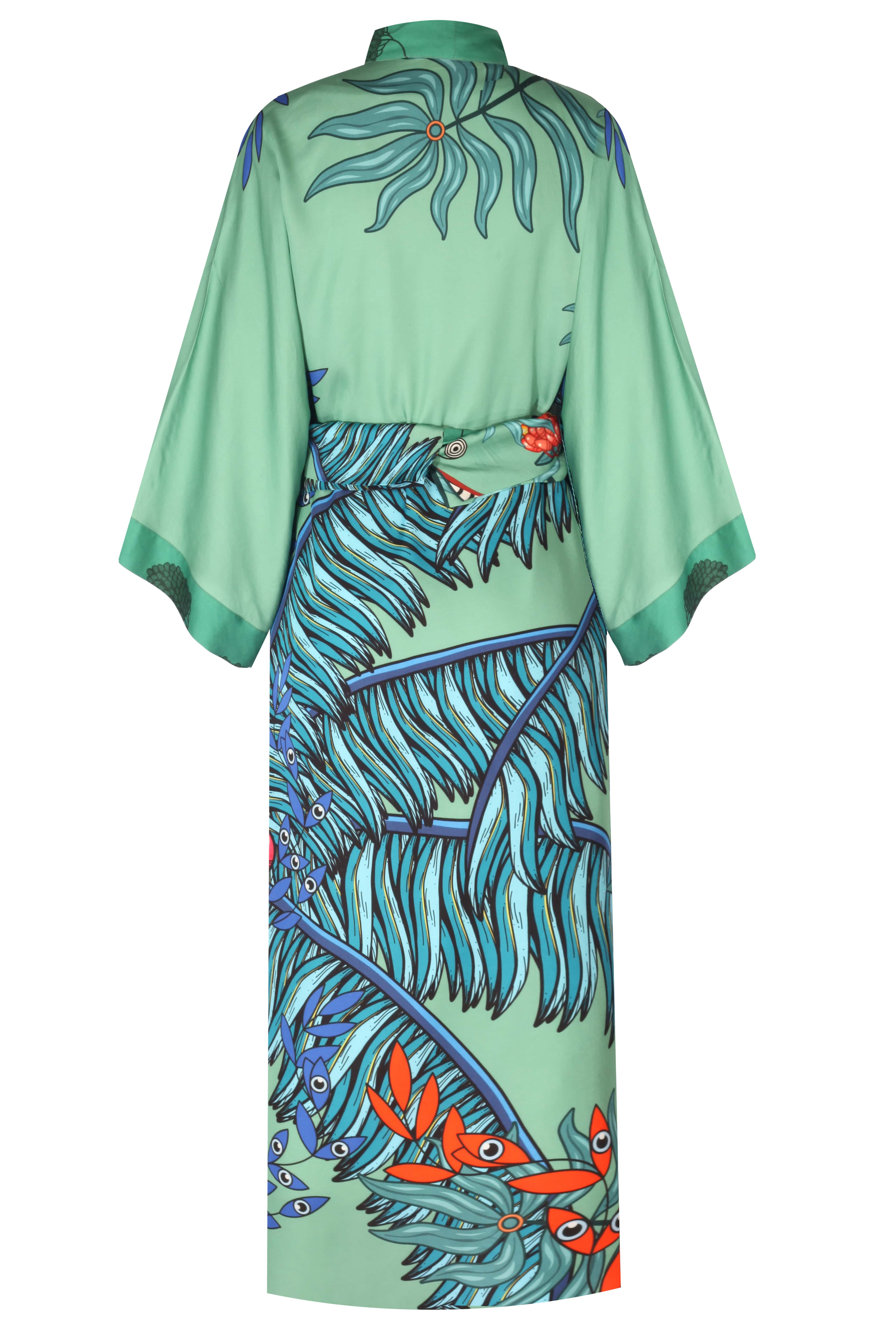 Back view of a Robina Caftan featuring vibrant green fabric with blue and colorful tropical leaf patterns.